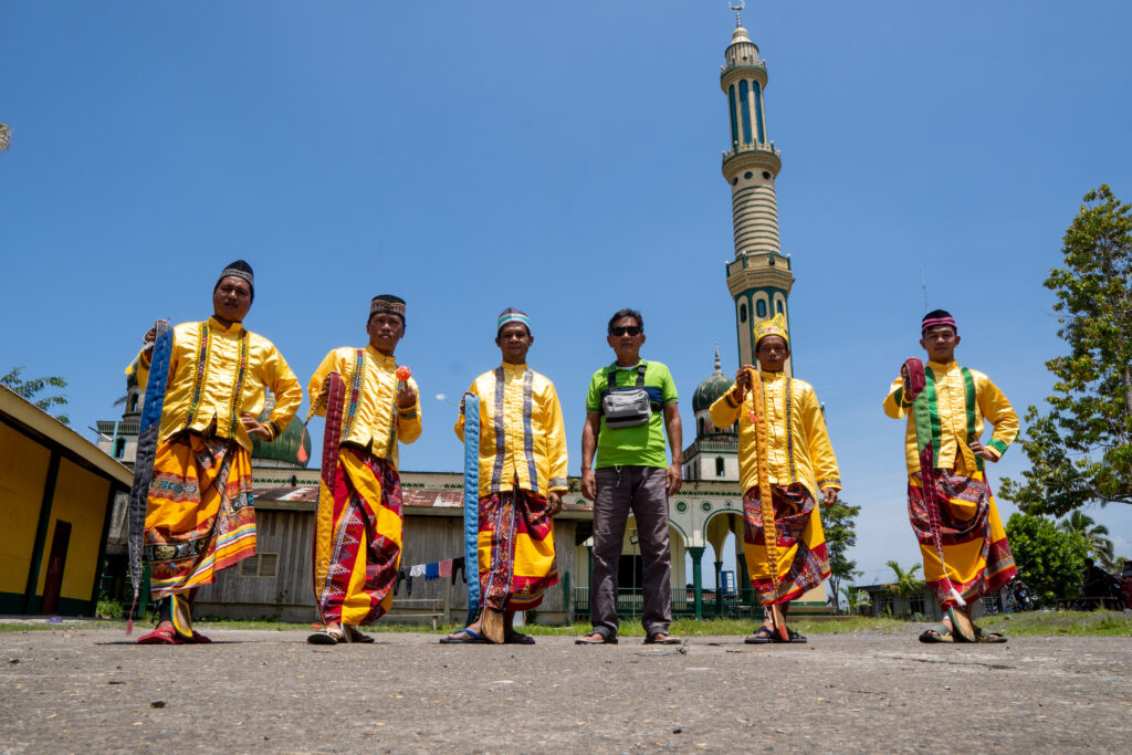Prominent sipa players from Butig, with the mosque as their backdrop.
